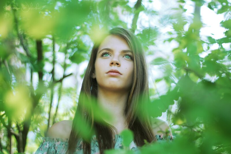 woman in forest with green leaves