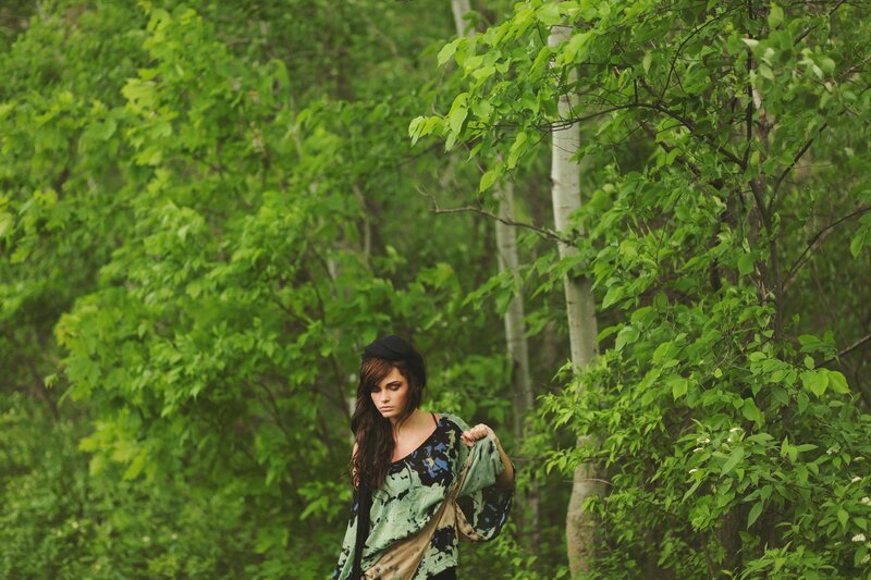 woman in forest with green top