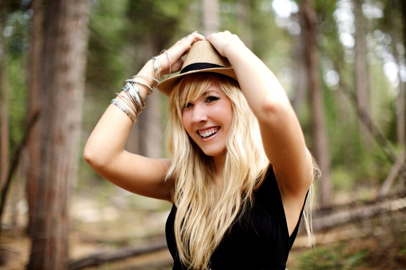woman in forest with hat