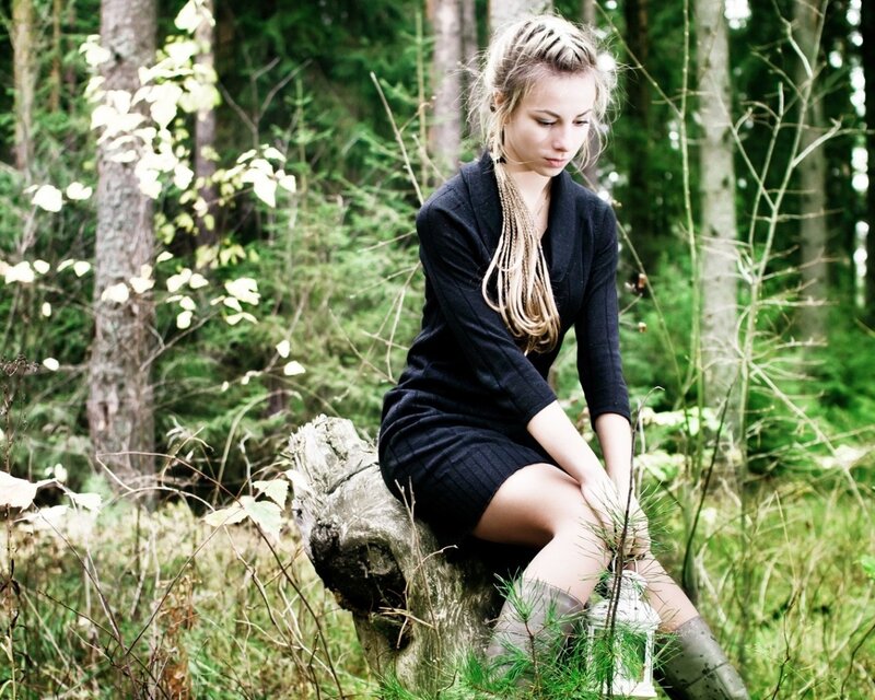 Woman in forest with lantern