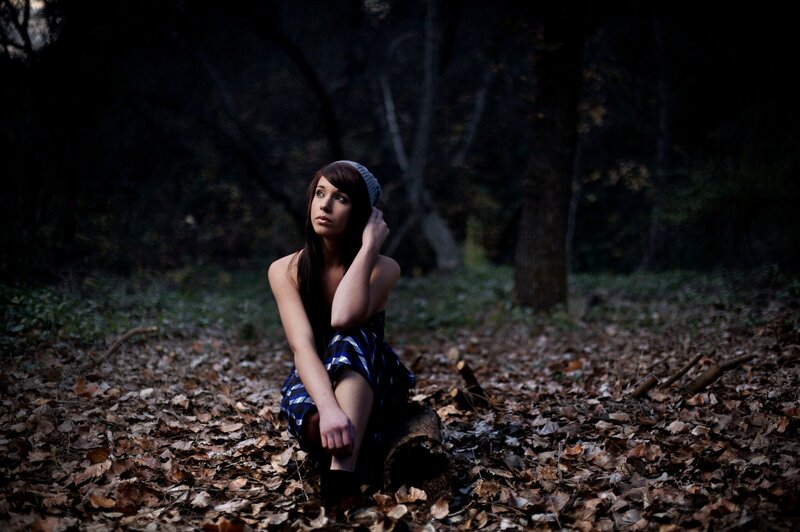 woman in forest with leaves