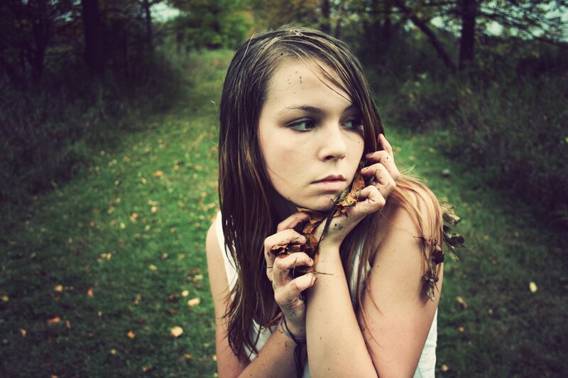 woman in forest with leaves