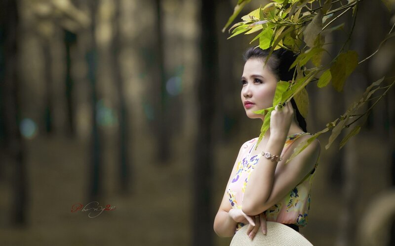 woman in forest with leaves