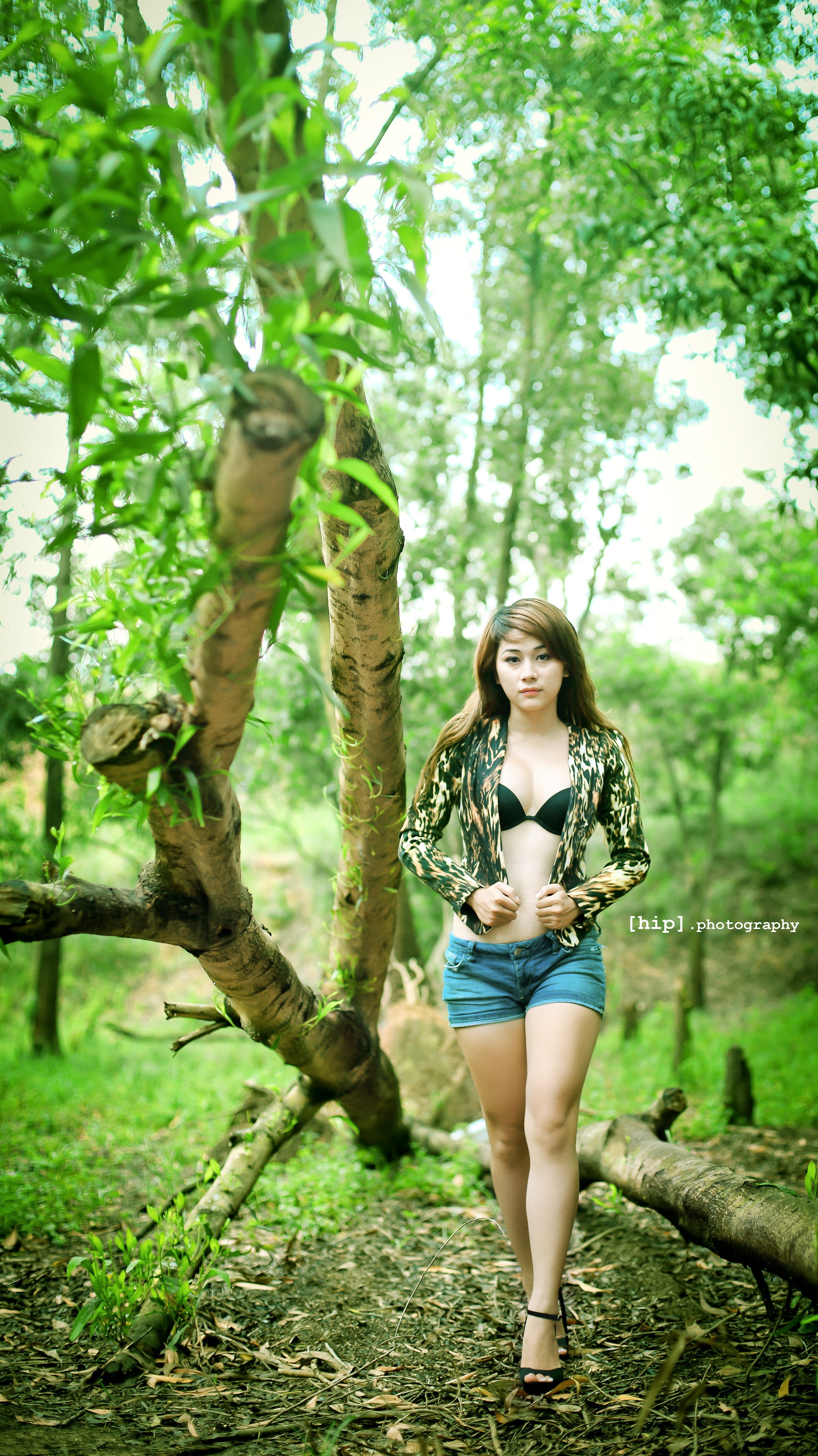 woman in forest with leopard jacket