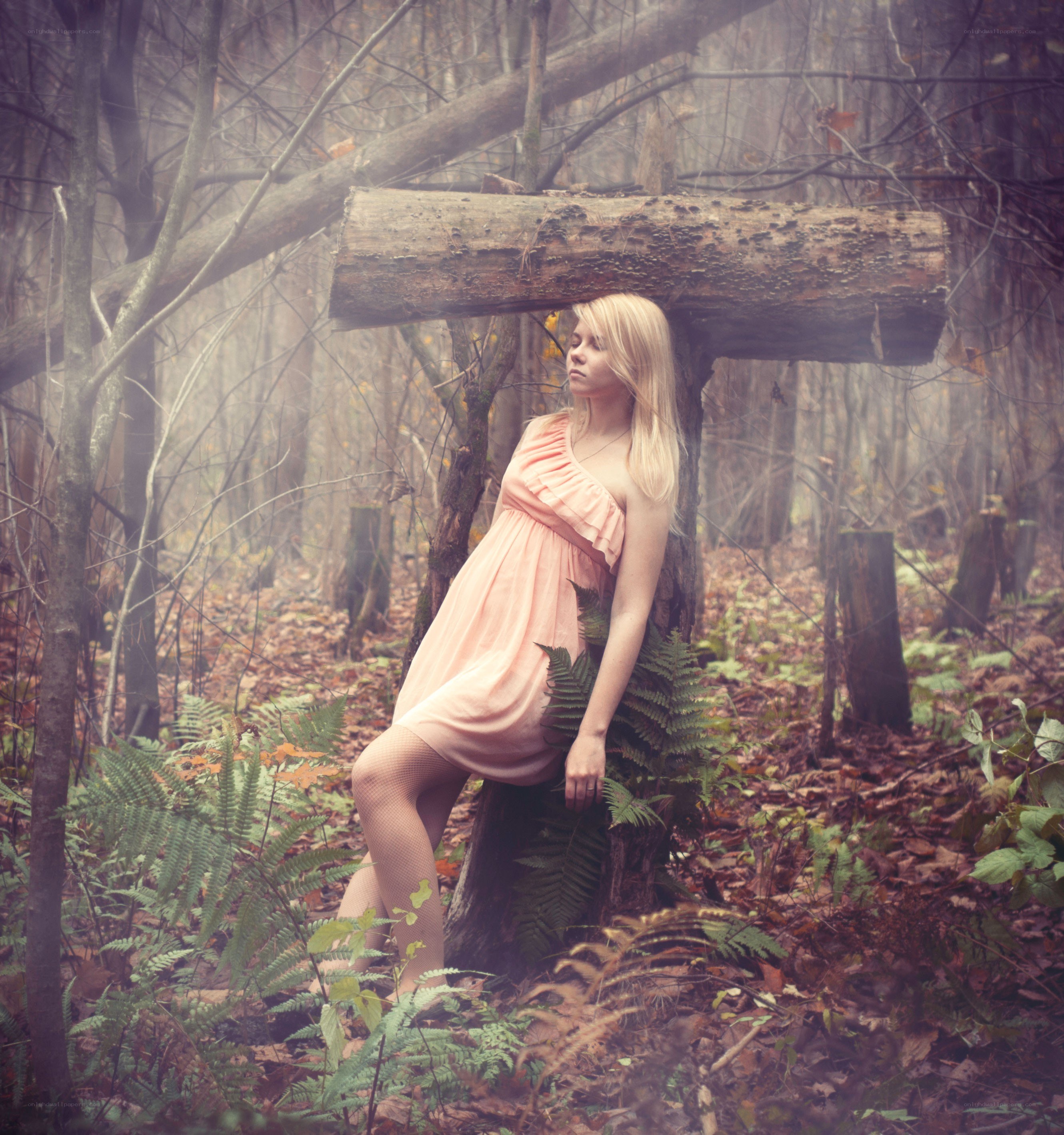 Woman in forest with log
