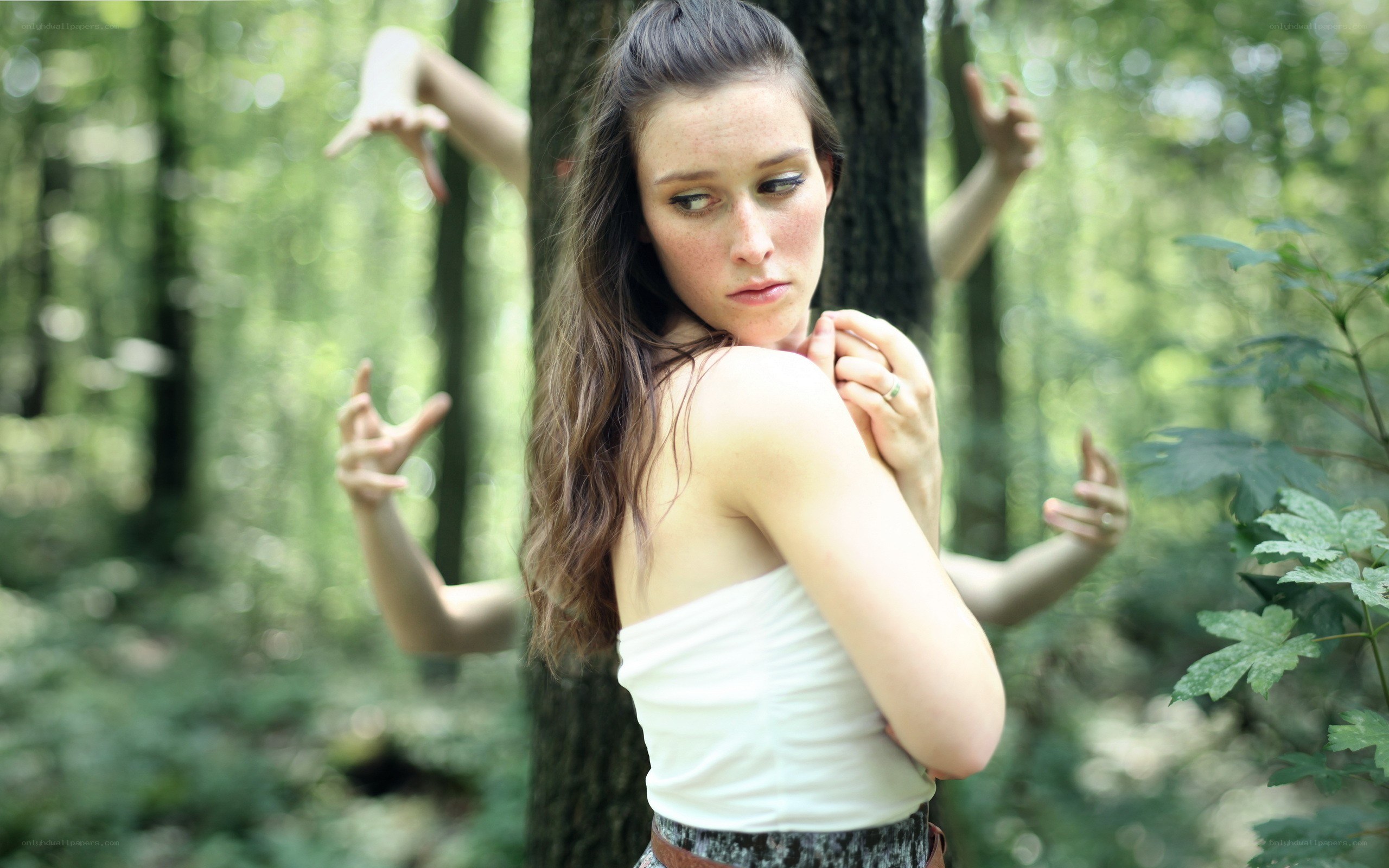 woman in forest with multiple arms
