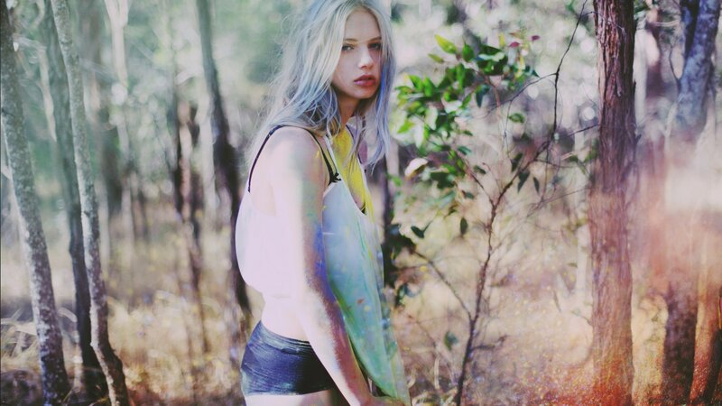 woman in forest with paint