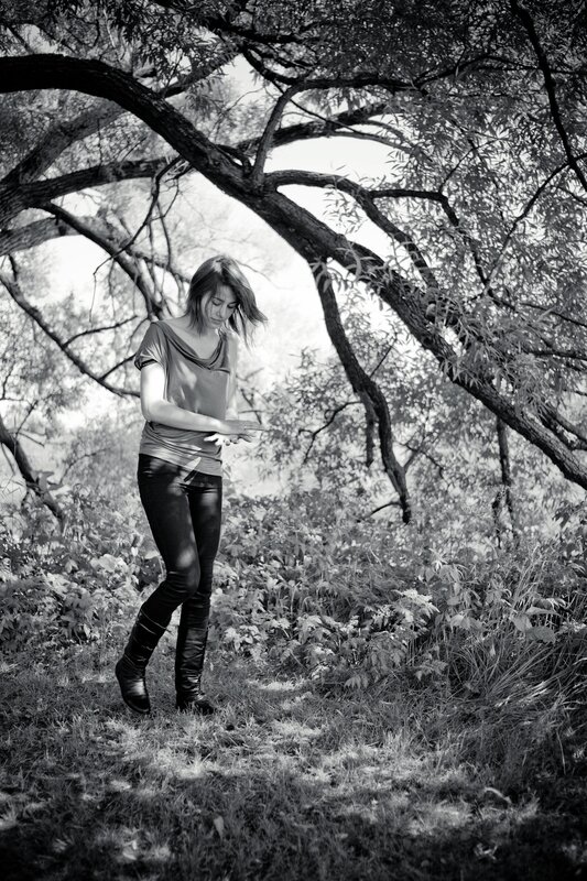 woman in forest with phone
