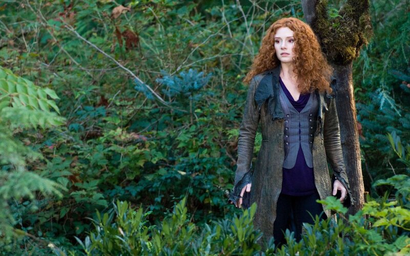 Woman in forest with red hair