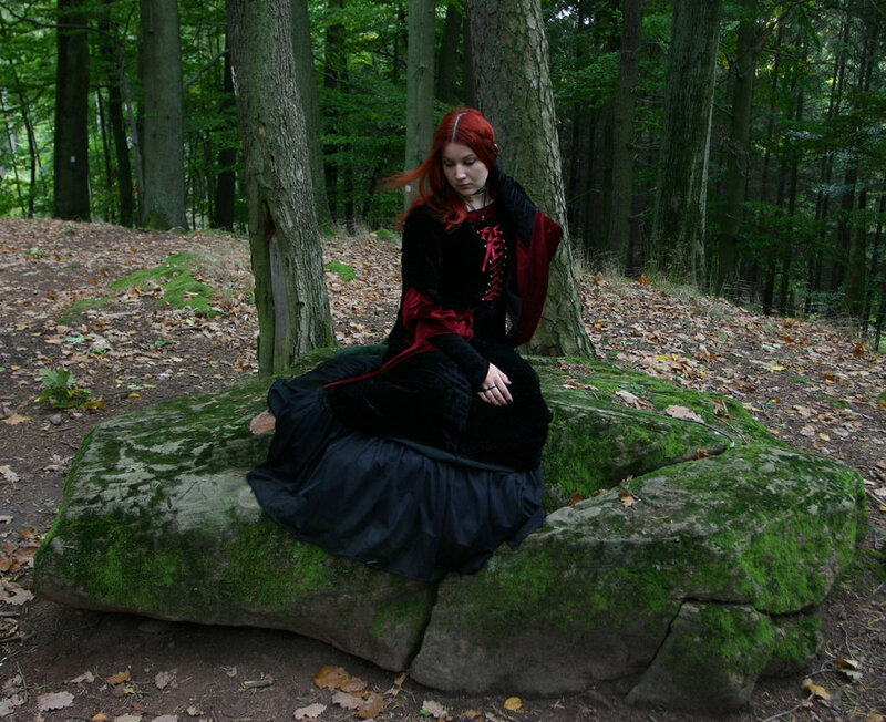 Woman in forest with red hair