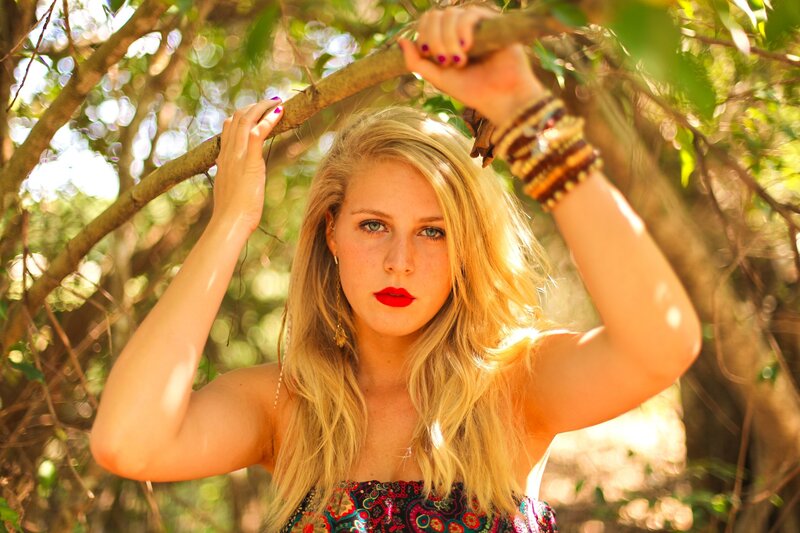 woman in forest with red lipstick