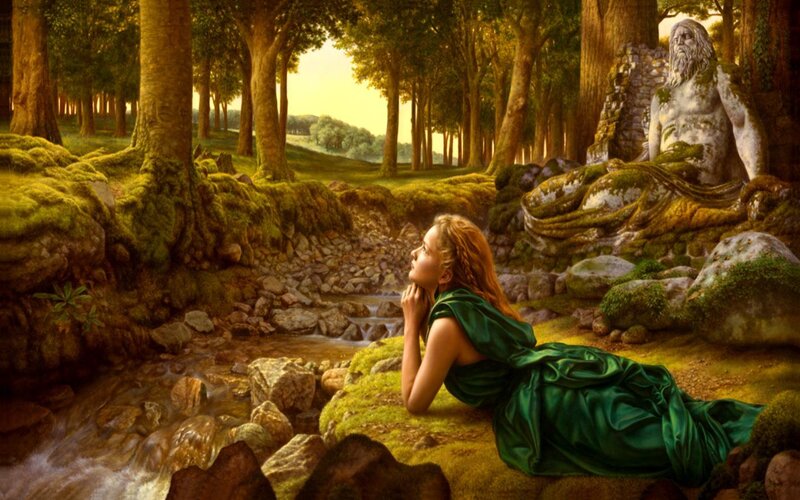 Woman in forest with stone statue