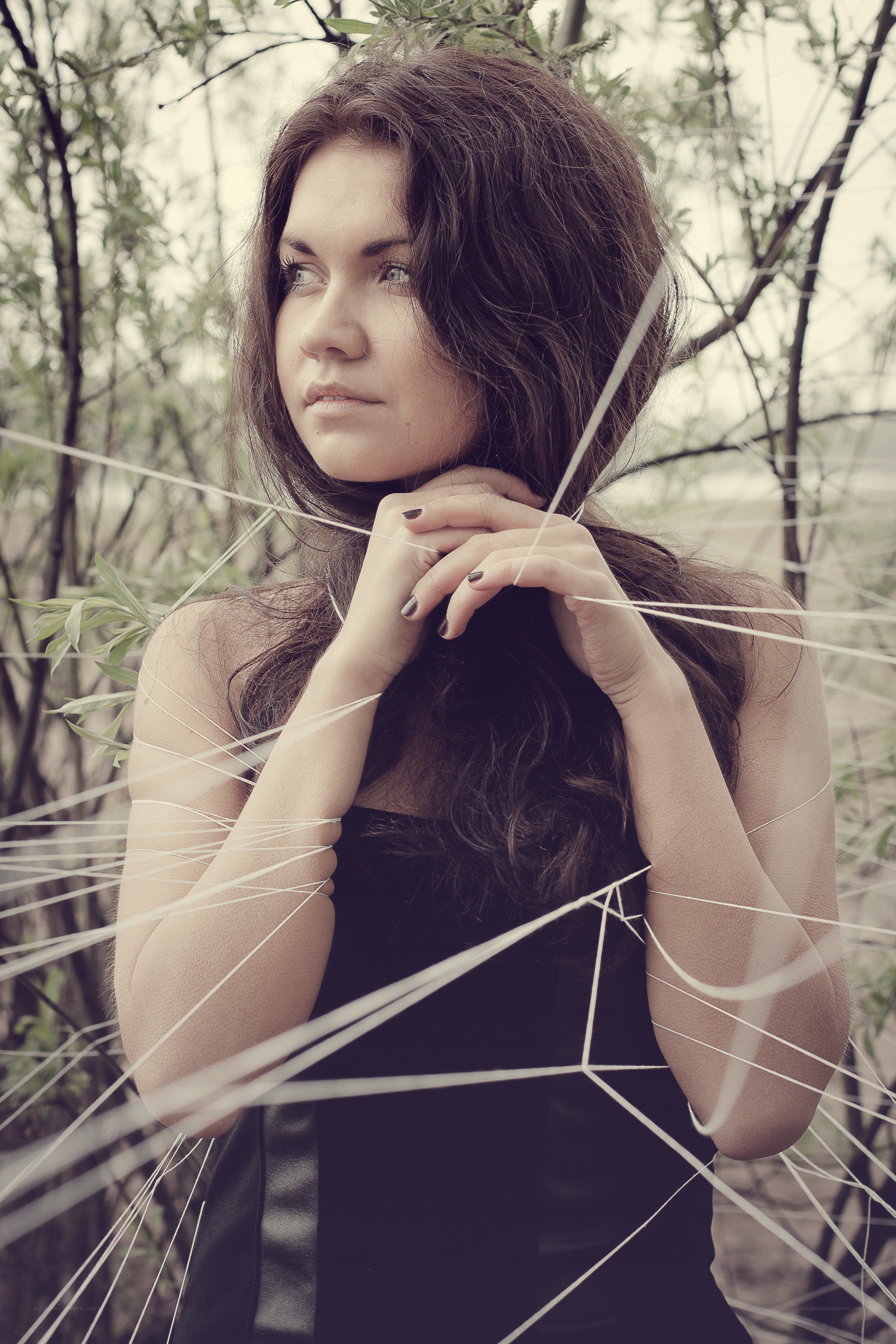 woman in forest with strings