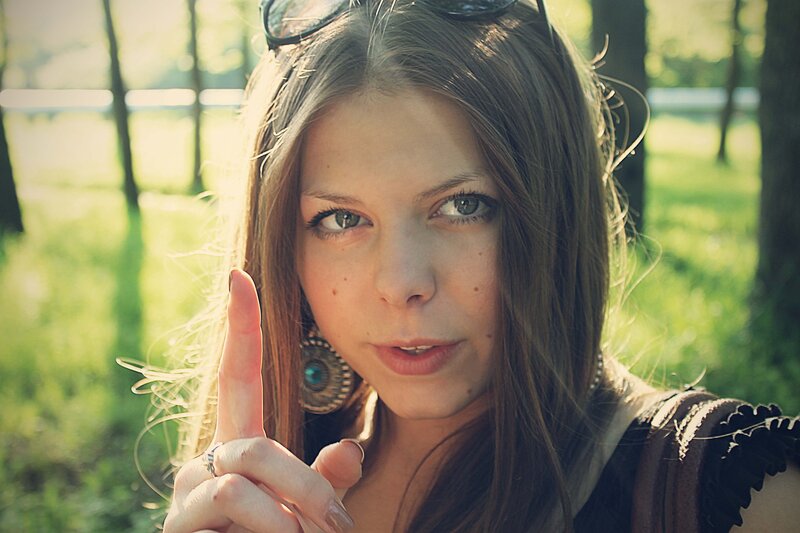 woman in forest with sunglasses