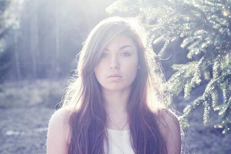 woman in forest with sunlight