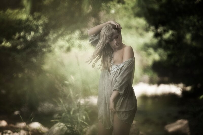 woman in forest with sunlight