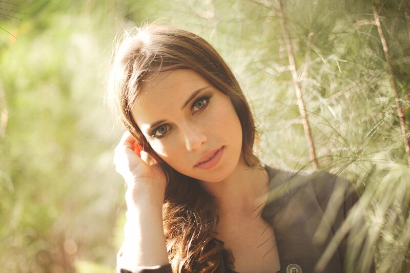 woman in forest with sunlight