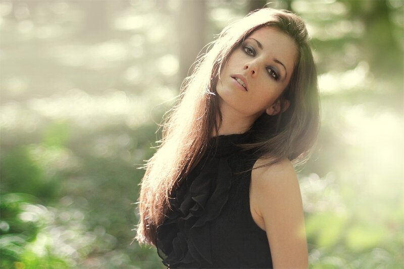 woman in forest with sunlight