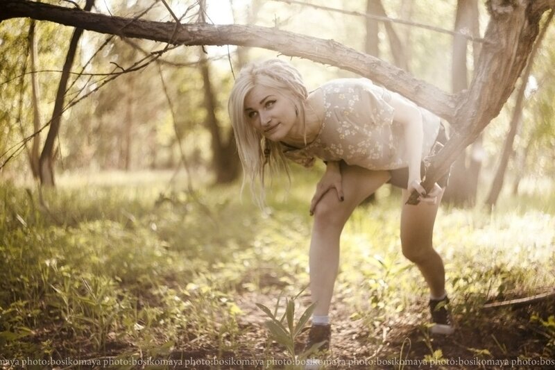 Woman in forest with sunlight