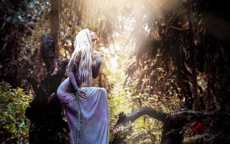 woman in forest with sunlight