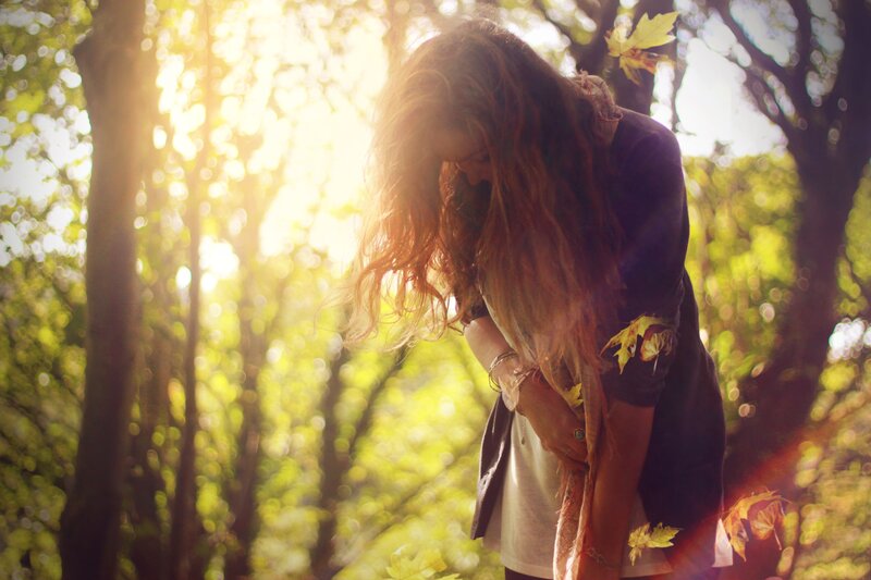 woman in forest with sunlight