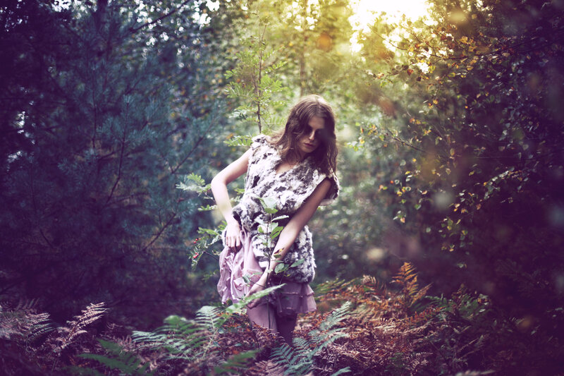 woman in forest with sunlight