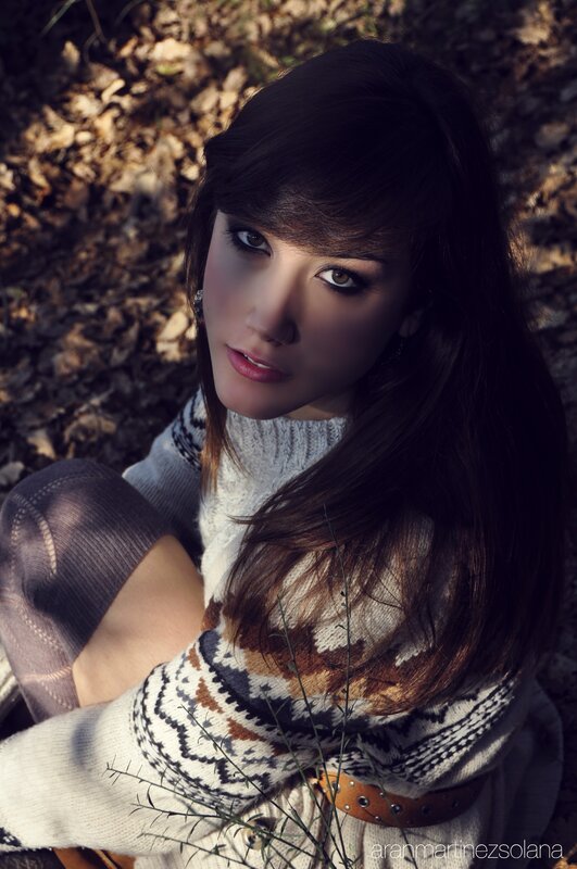 woman in forest with sweater