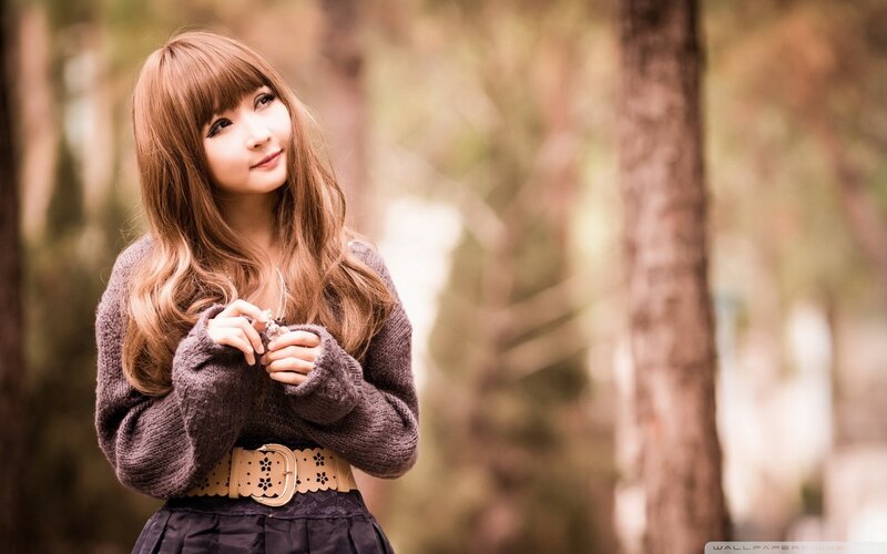 woman in forest with sweater