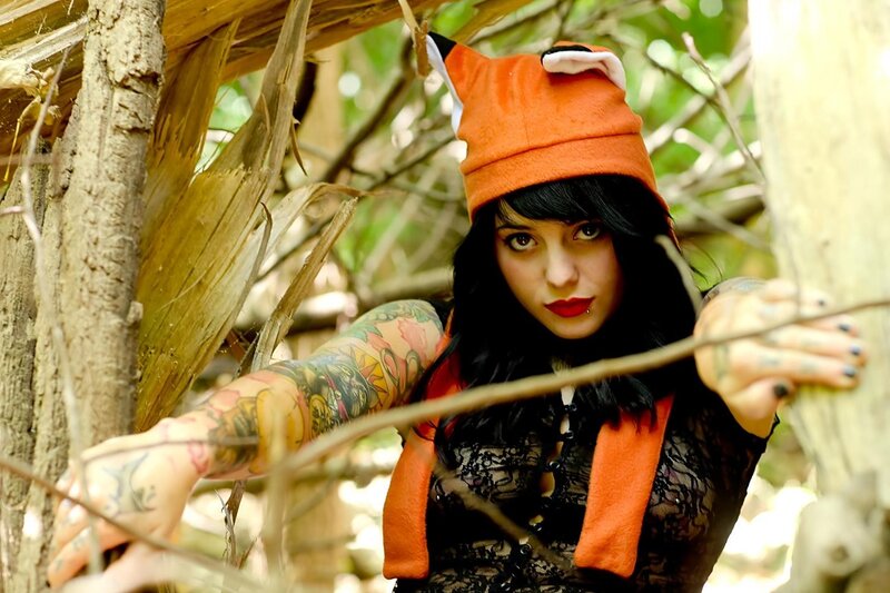 Woman in forest with tattoos
