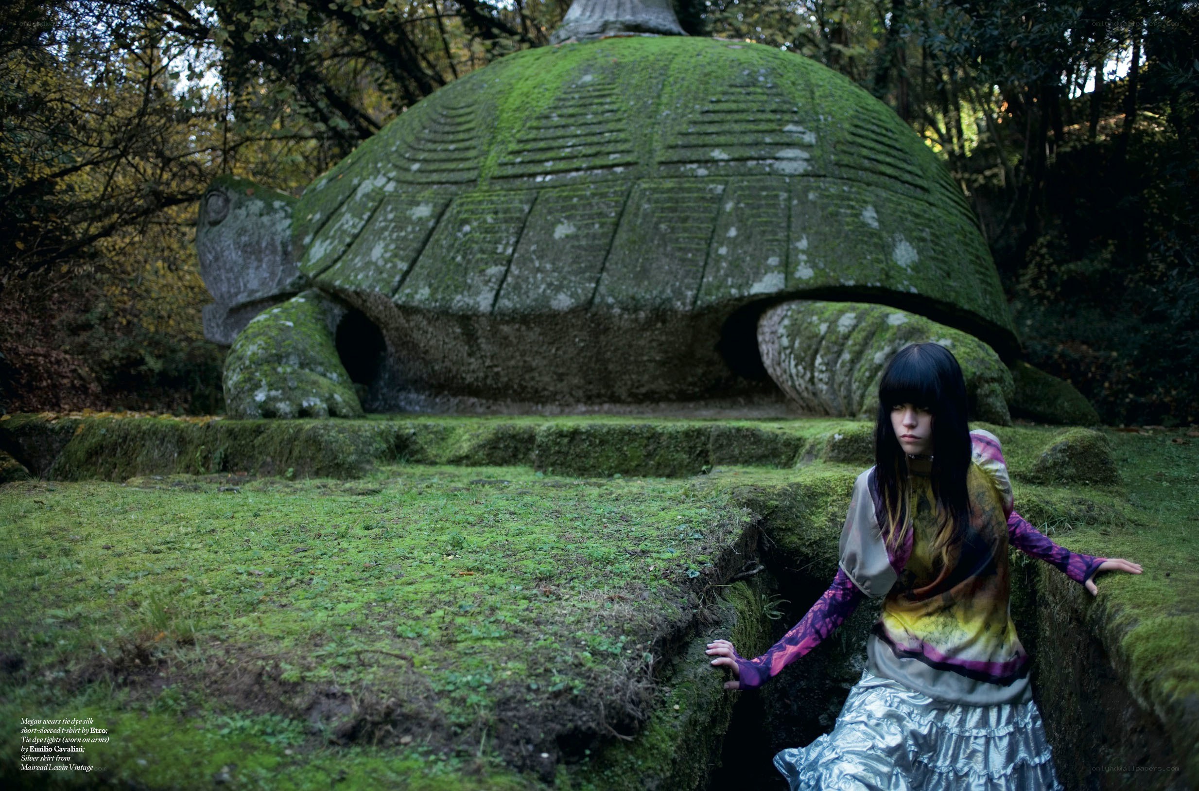 Woman in forest with turtle statue