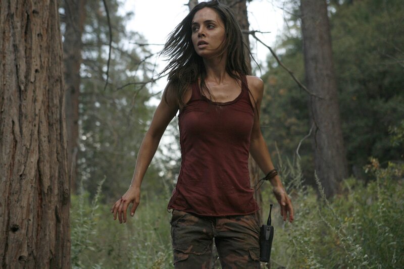 woman in forest with walkie-talkie