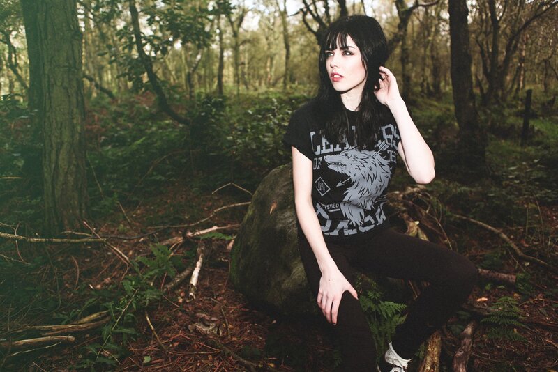 Woman in forest with wolf t-shirt