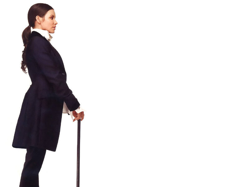 woman in formal coat holding cane