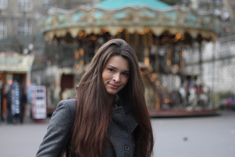 woman in front of carousel