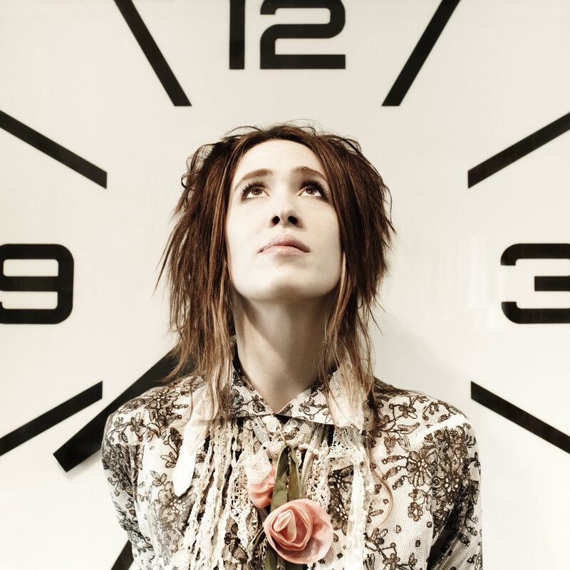 woman in front of clock