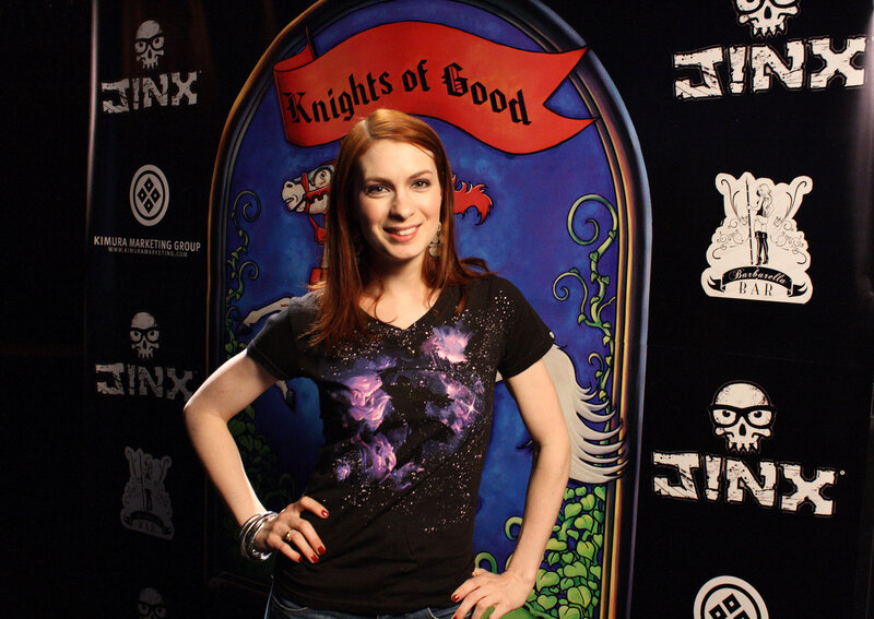 Woman in front of Knights of Good backdrop