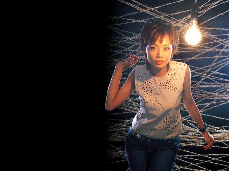 woman in front of light bulb