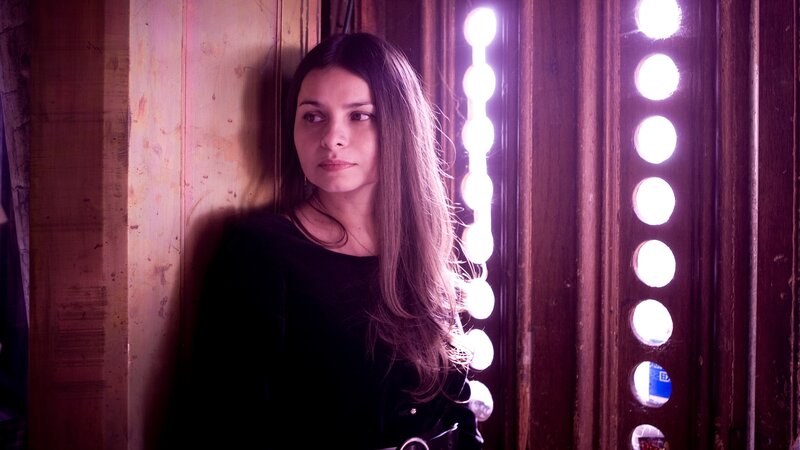 woman in front of lighted mirror
