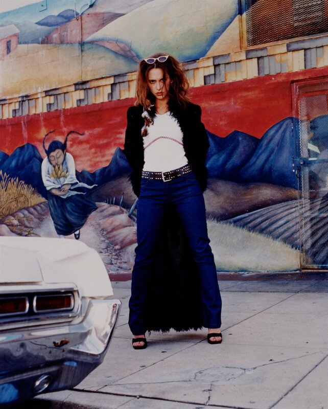 Woman in front of mural
