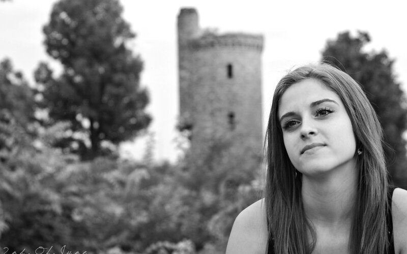 woman in front of old tower