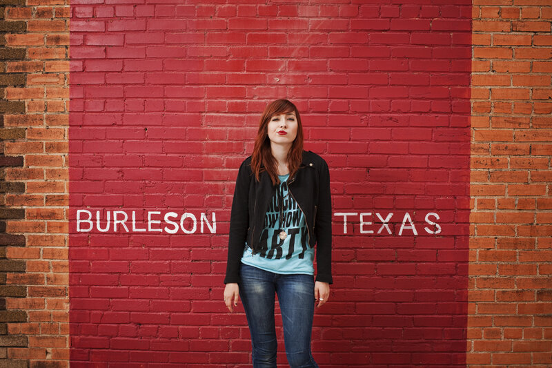 woman in front of red wall