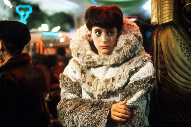 Woman in fur coat at night