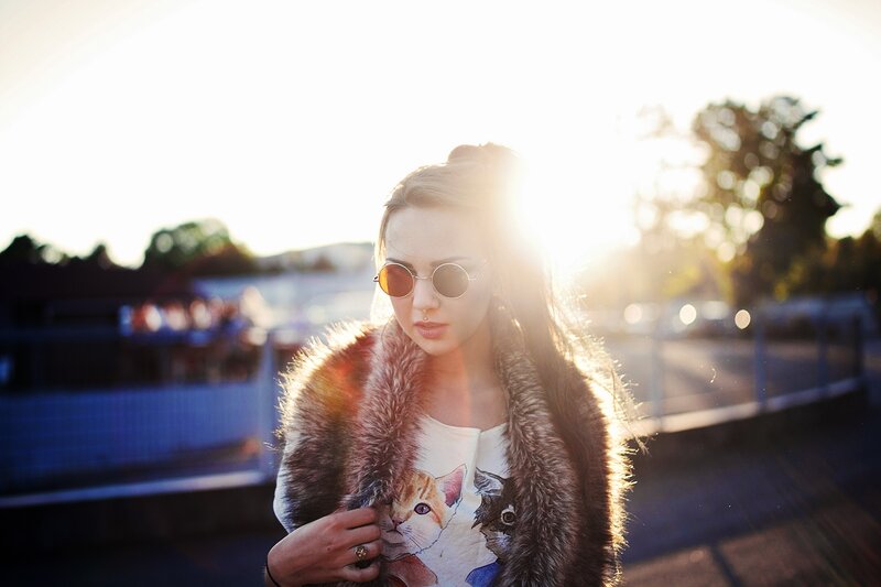 woman in fur coat at sunset