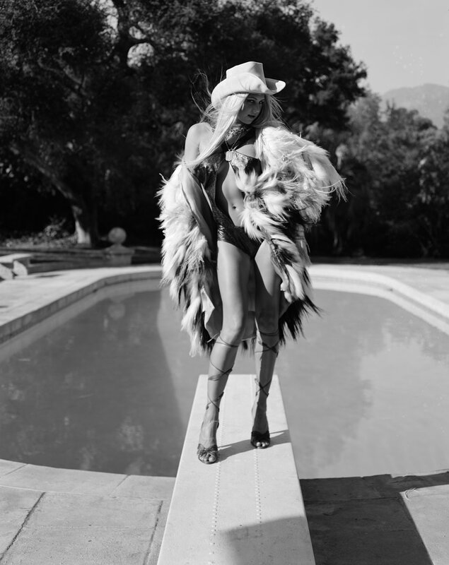 woman in fur coat by pool