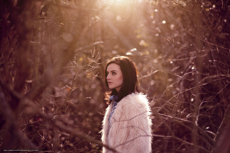 Woman in fur coat in forest