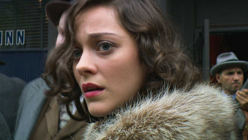 woman in fur coat looking concerned