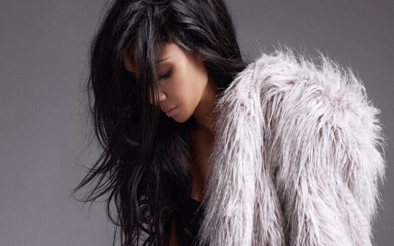 woman in fur coat looking down