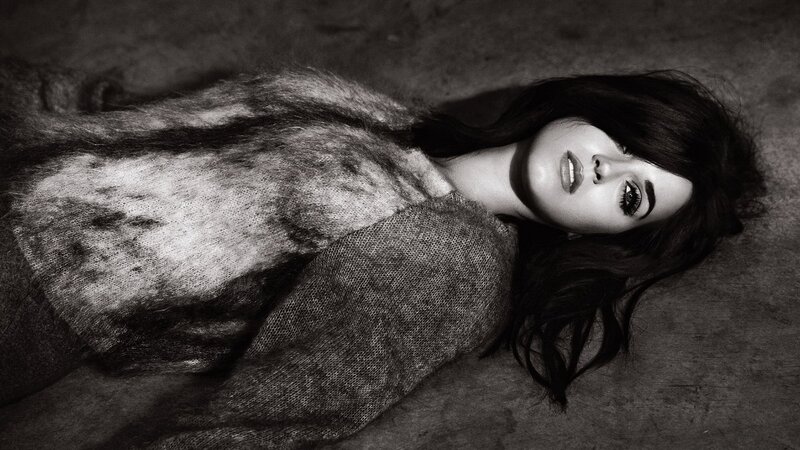 woman in fur coat lying down
