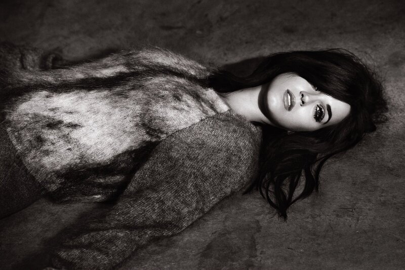 woman in fur coat lying down