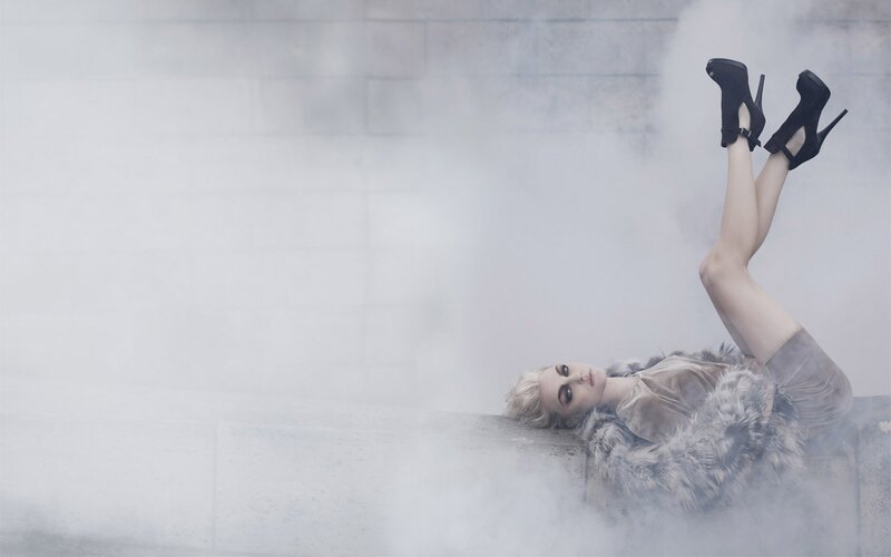 woman in fur coat lying down